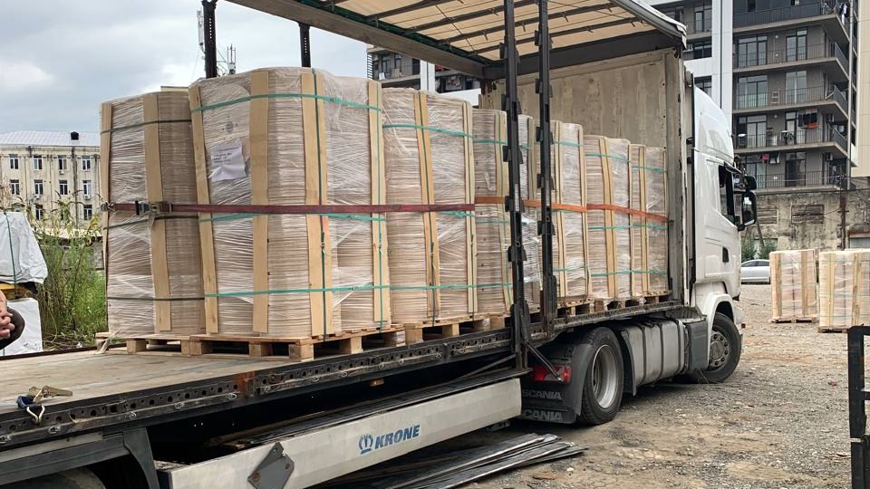 Palletized plywood components loaded in a curtain-side truck